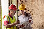 Construction workers examining papers