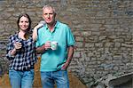 Father and daughter drinking tea in yard