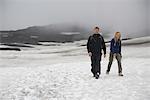 Hikers walking in snowy landscape