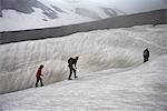 Family hiking on snowy hillside