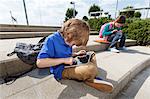 Boy using tablet computer outdoors