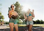 Teenage girls playing basketball