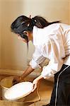 Woman mixing up paint for wall