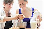 Teenage girls cooking together