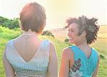 Smiling women standing in meadow