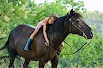 Girl lying on horse