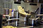 Potatoes being tossed in a pan