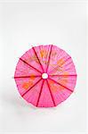 A pink cocktail umbrella
