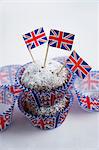 Chocolate muffins dusted with icing sugar and flags (Great Britain)