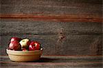 A Bowl of Assorted Apples in a Rustic Setting