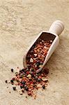 Mexican spice mixture in a wooden scoop