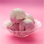Raspberry and vanilla ice cream in a glass bowl