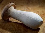 A king trumpet mushroom on a chopping board