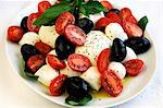 Mozzarella with tomatoes, basil and olives