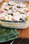 Unbaked lasagne with artichokes and ham in a baking dish