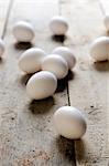 White eggs on a wooden surface