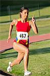 Female athlete running on track