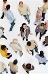 Woman standing in crowd of people, high angle view