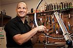 Man fixing bicycle rim in workshop