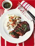 Grilled and sliced beef steak, potato salad with scallion