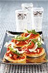 Sun-dried tomatoes and rocket mini pizzas