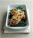 Chicken breasts marinated with herbs and pepper on a bed of green beans