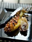 Roast pineapple cooked on the spit with caramelized chicory