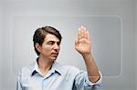 Man using large transparent touch screen to authenticate his handprint