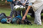 Campers unloading camping gear, low section