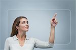 Woman using large transparent touch screen