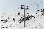 Skiers riding on ski lift at ski resort