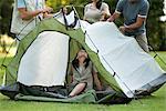 Campers setting up tent