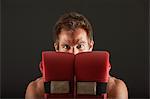 Boxer holding up gloves in front of face in defensive position