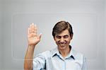 Man using large transparent touch screen to authenticate his handprint