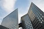 Facade of modern office buildings against sky, low angle view