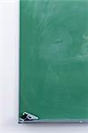 Handgun resting on blackboard in classroom