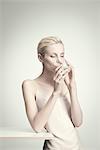 Young woman drinking water from glass, portrait