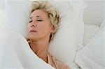 Mature woman sleeping in bed