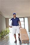 Happy African American delivery man with packages