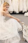 Beautiful young woman confused with footwear selection in bridal store