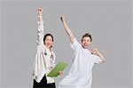 Portrait of doctor and patient cheering up with raised arms