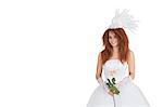 Portrait of elegant brunette in wedding dress holding rose over white background