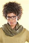 Portrait of an African American woman wearing glasses over colored background