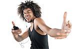 Portrait of a happy young man in vest dancing to tunes of mp3 player over white background