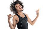 Portrait of a happy young man gesturing while listening to mp3 player over white background