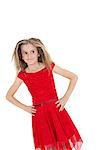 Tilt image of girl in red frock with hands on hips over white background