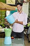 Portrait of handsome man holding a souvenir in store