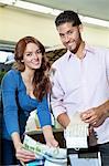 Portrait of young couple with textile samples in store