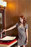 Portrait of beautiful young woman standing near sink in model home