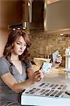 Beautiful young woman looking at tile samples in model home